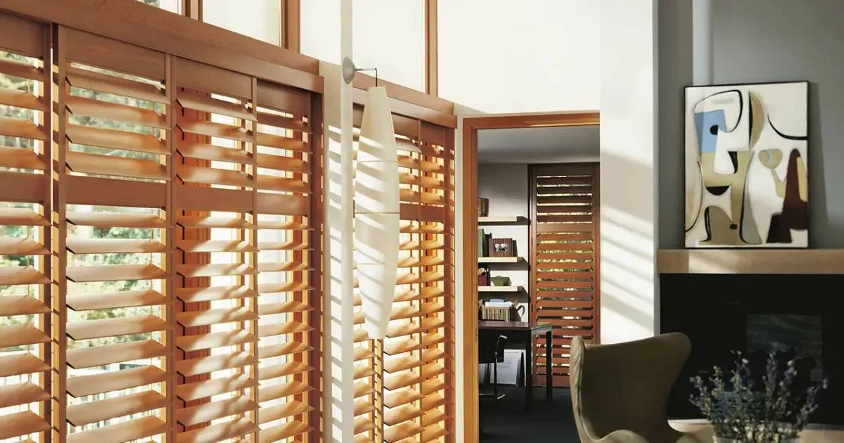 a well-furnished bedroom with a cozy bed, a stylish dresser, and window blinds for privacy.