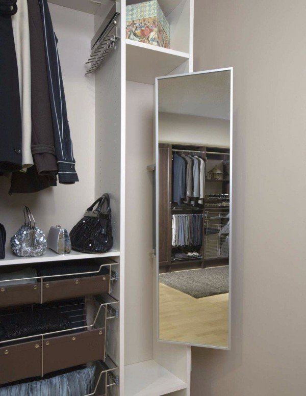 a closet with clothes and a mirror