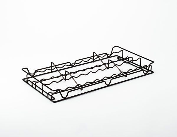 a black spice rack is sitting on a white surface .