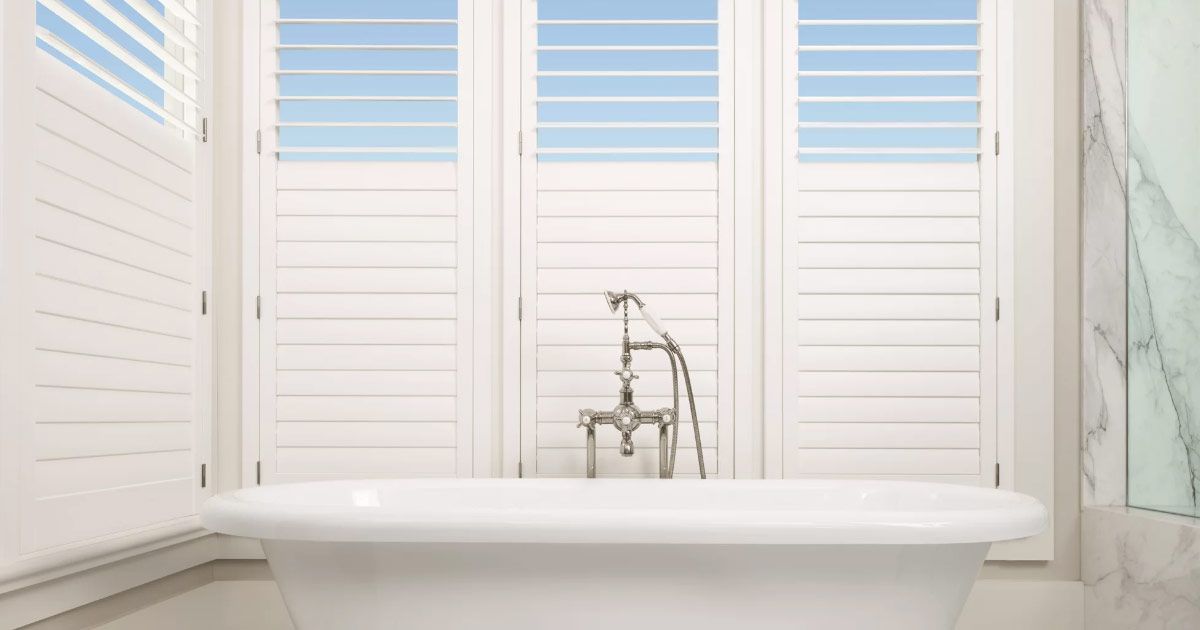 a living room entertainment center with a flat screen tv on the wall .