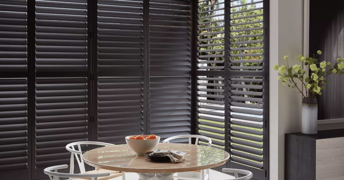 a wooden cabinet with clothes and a bag in it .