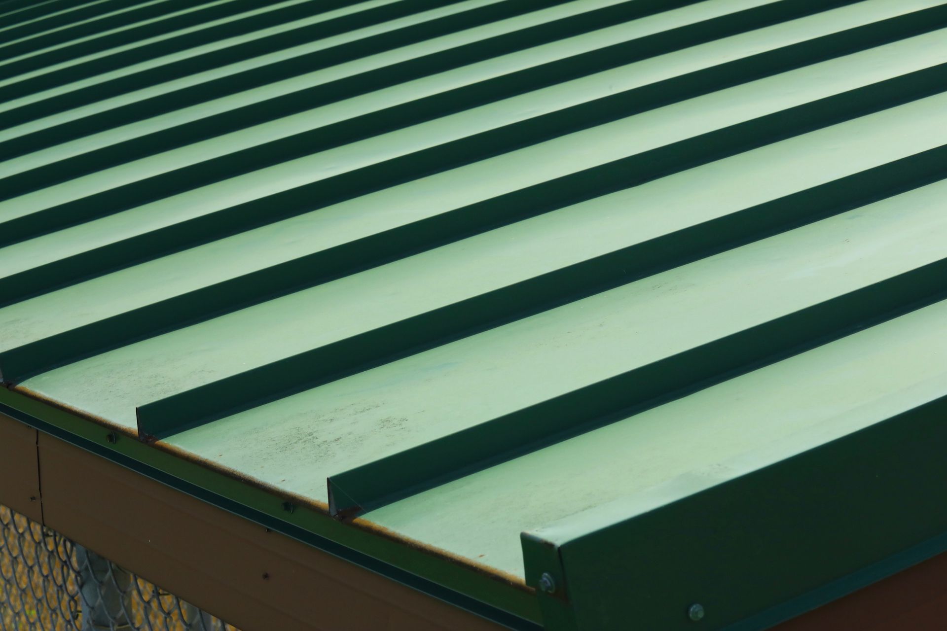 A close up of a green metal roof on a building.