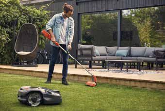 man trimming lawn grass