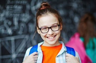 Girl smiling with eyeglasses — Premium Eyeglasses in Rapid City, SD