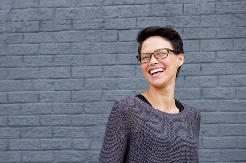 Beautiful mixed race womn laughing with glasses — Eyeglass Shop in Rapid City, SD
