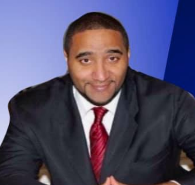 A group of people are posing for a picture at a bowling alley.