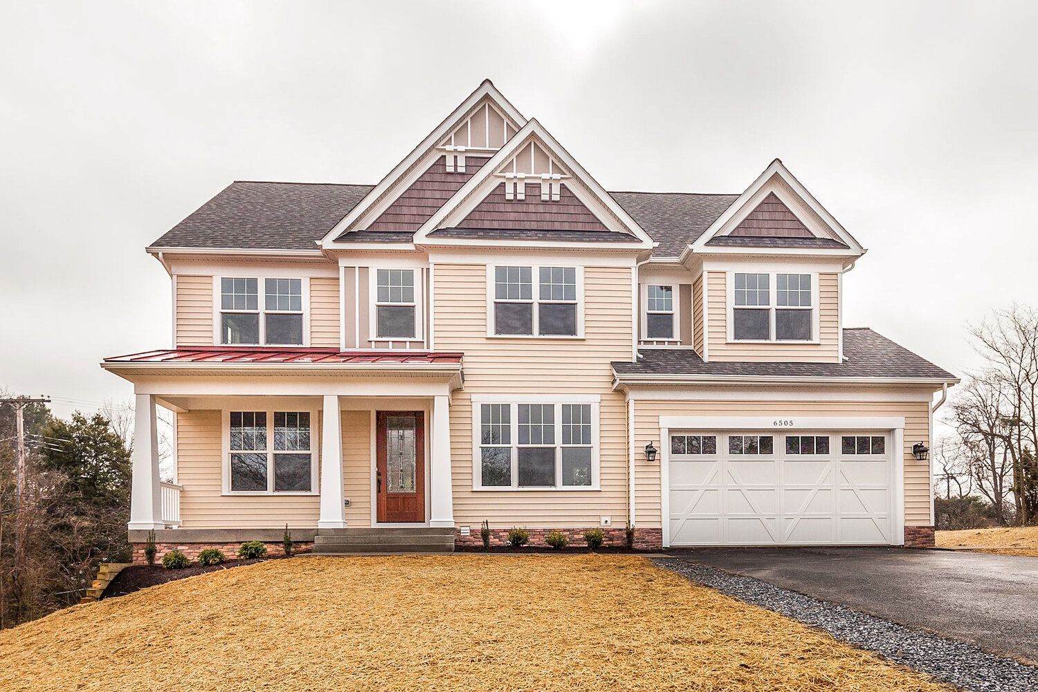 A large house with a white garage door and a lot of windows.