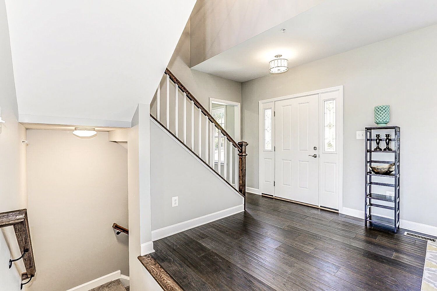 A hallway with stairs leading up to the second floor of a house.