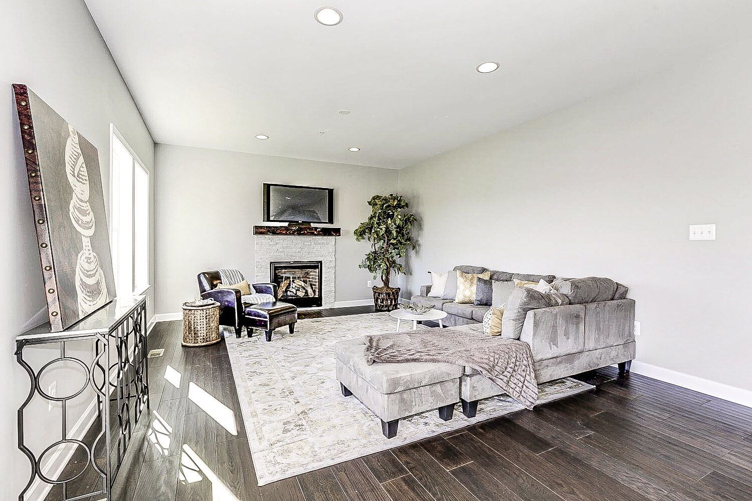 A living room with a couch , chairs , and a fireplace.