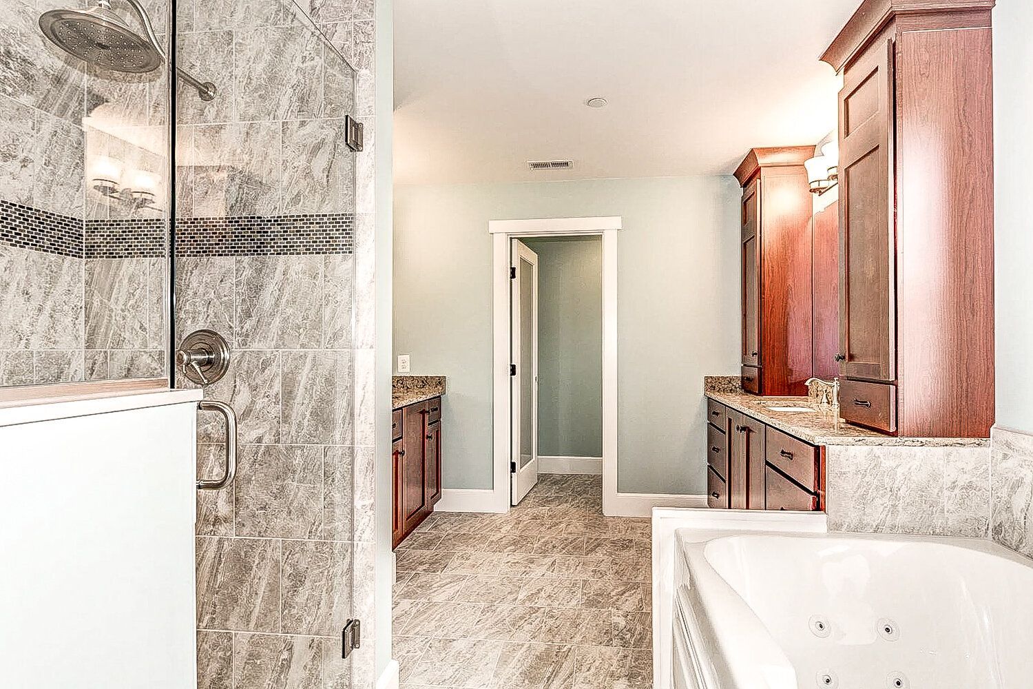A bathroom with a walk in shower and a bathtub.