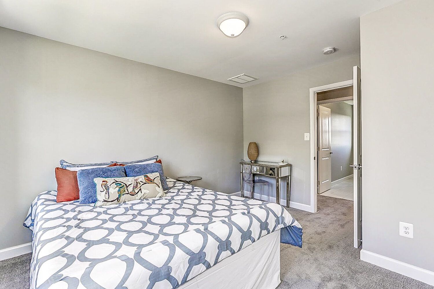 A bedroom with a king size bed and a walk in closet.