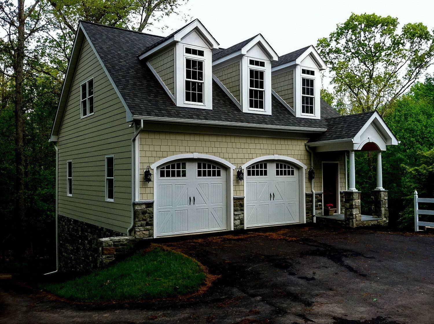 A house with three garage doors and a driveway