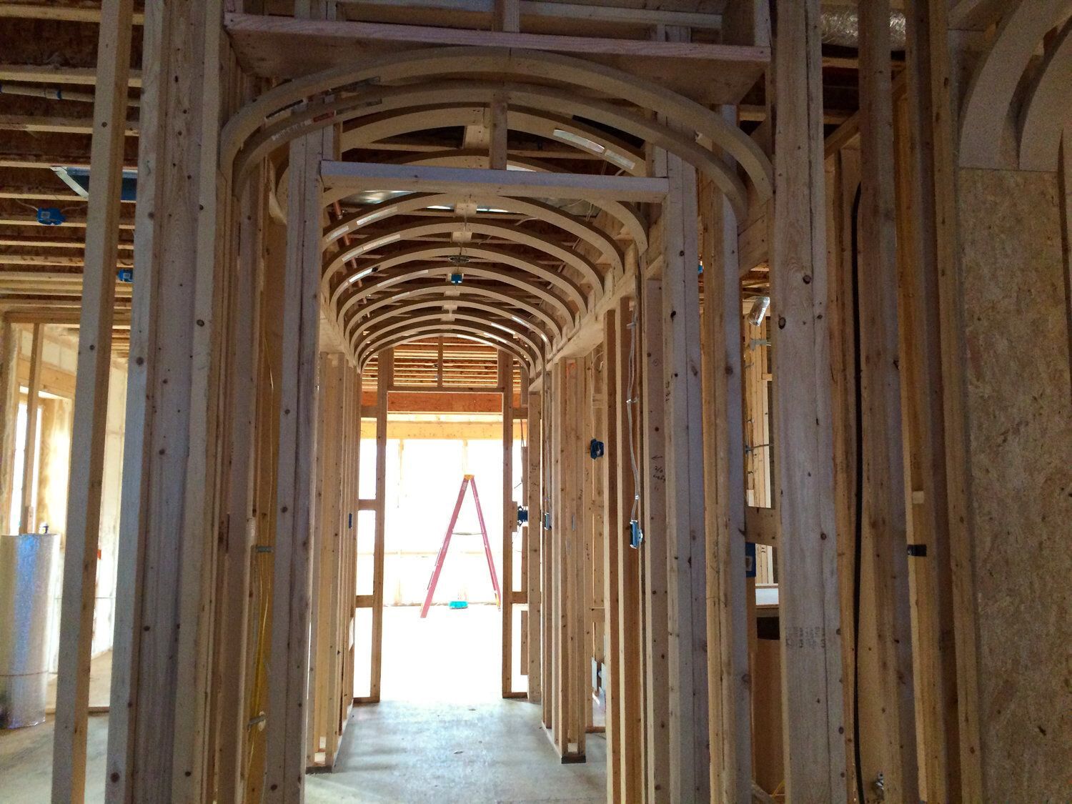 A ladder is sitting in the middle of a building under construction