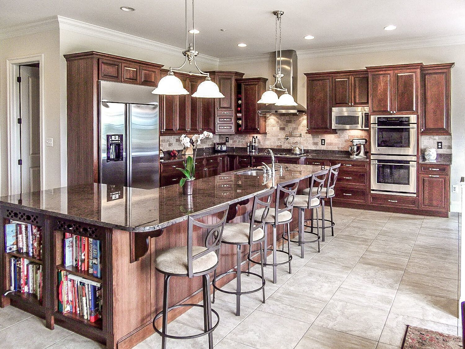 A kitchen with a large island and stools