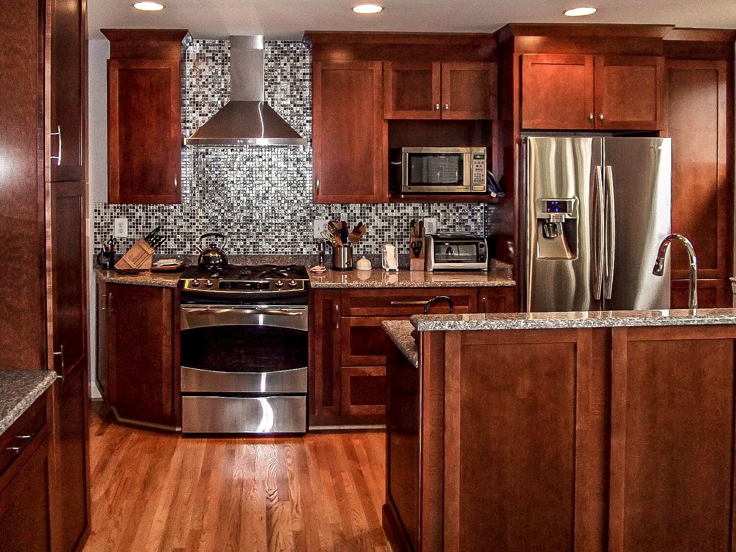 A kitchen with stainless steel appliances and wooden cabinets