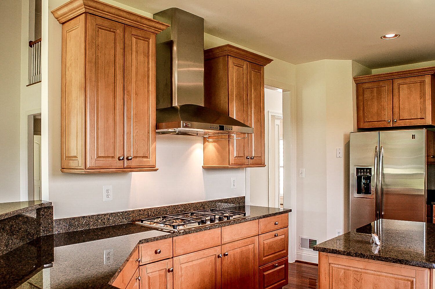 A kitchen with stainless steel appliances and wooden cabinets