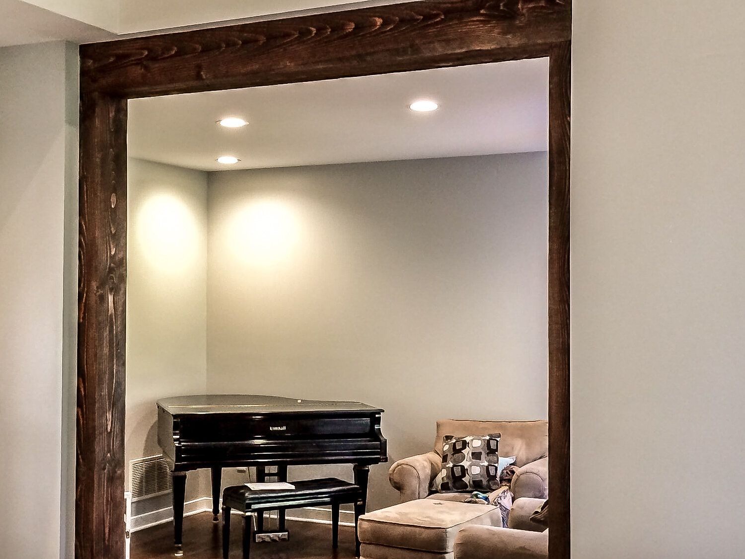 A living room with a piano and a chair