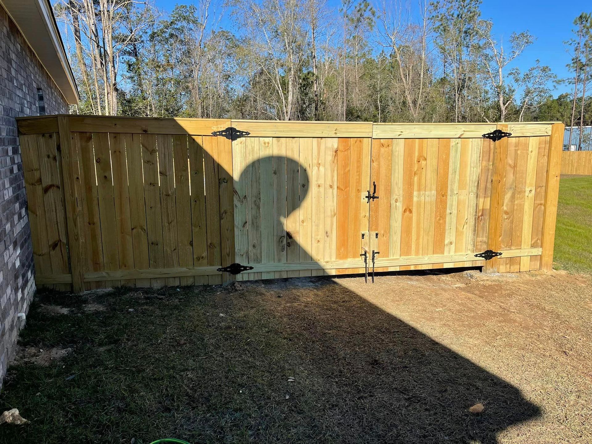 A Wooden Fence with A Gate in The Backyard - Mississippi, United States - Magnolia Fencing, LLC