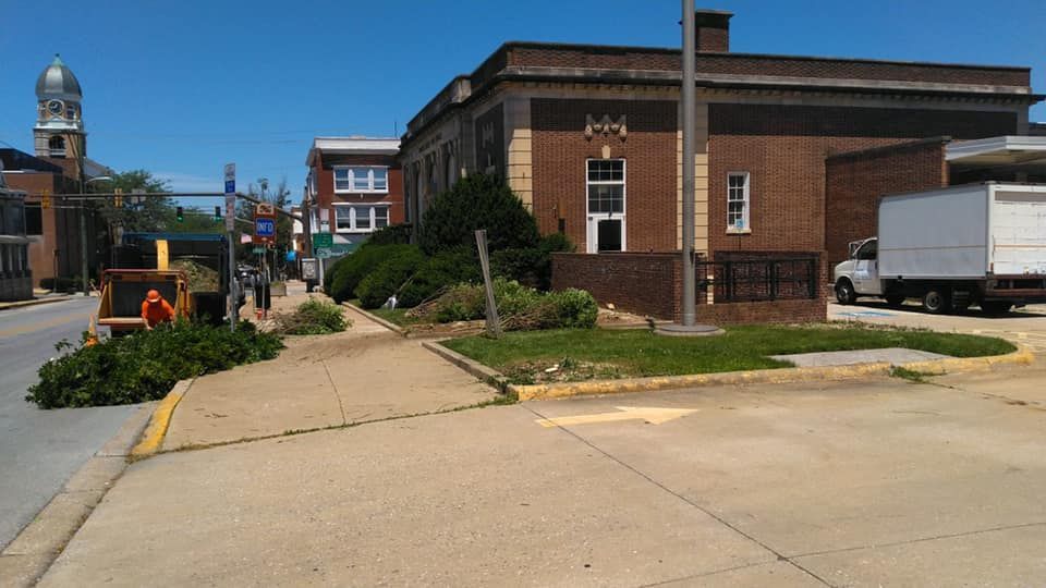 A white truck is parked in front of a brick building