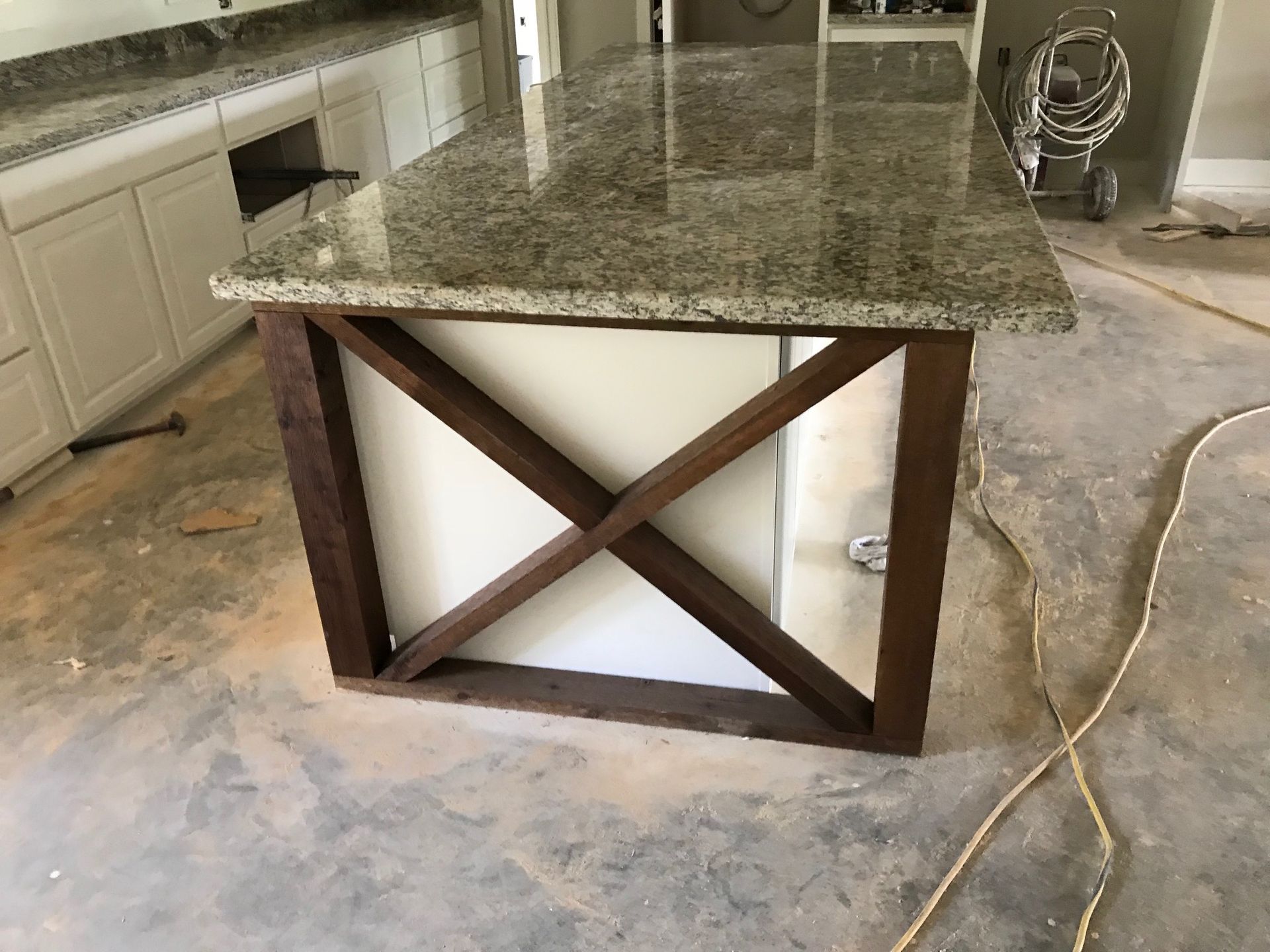 Kitchen island with granite countertop and dark wood