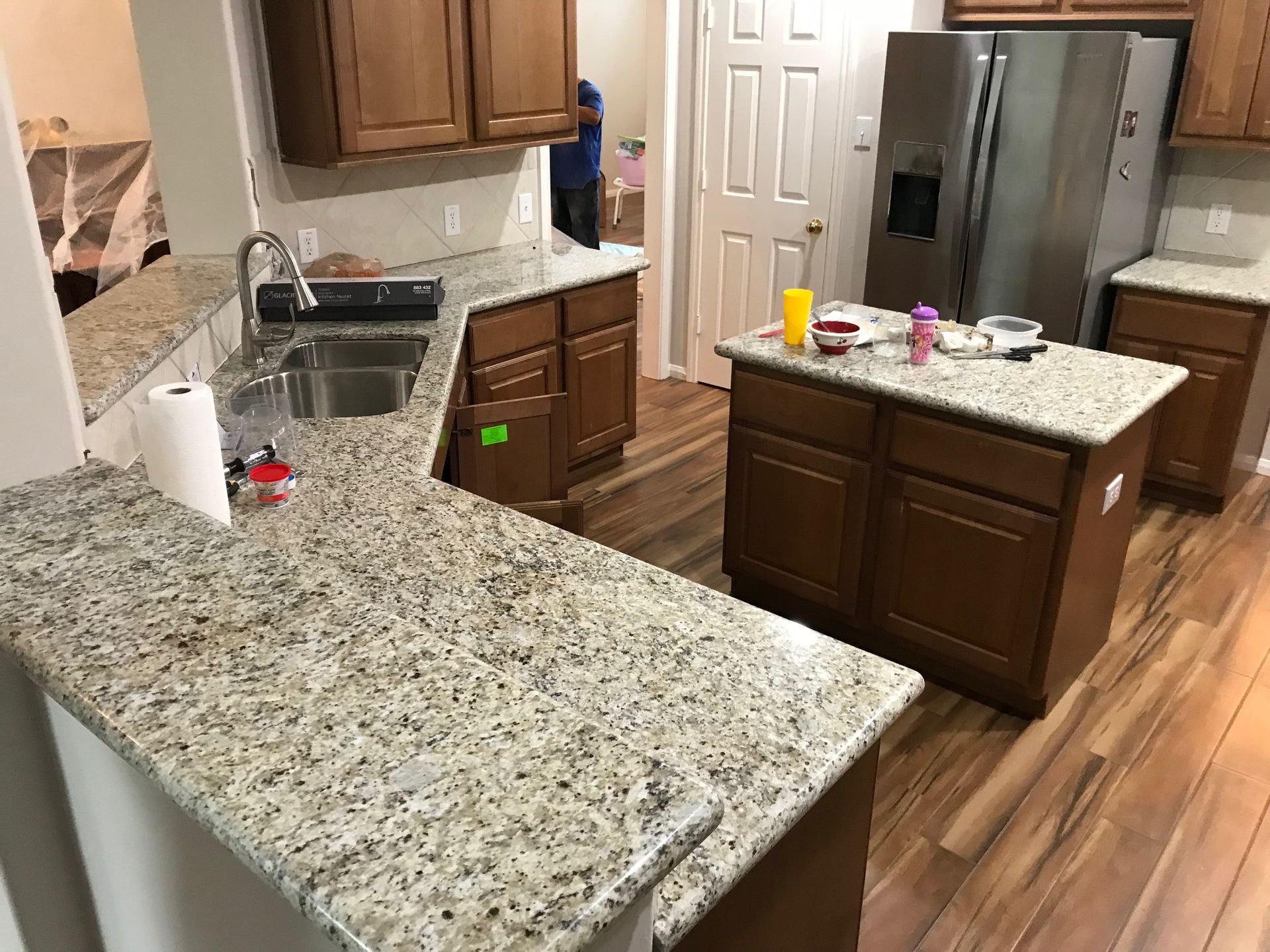 Kitchen with brown cabinets, granite countertops, and stainless steel appliances.