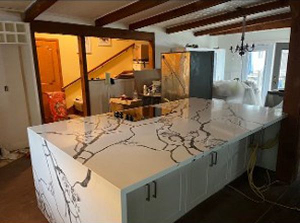 A kitchen with a large island in the middle of the room.