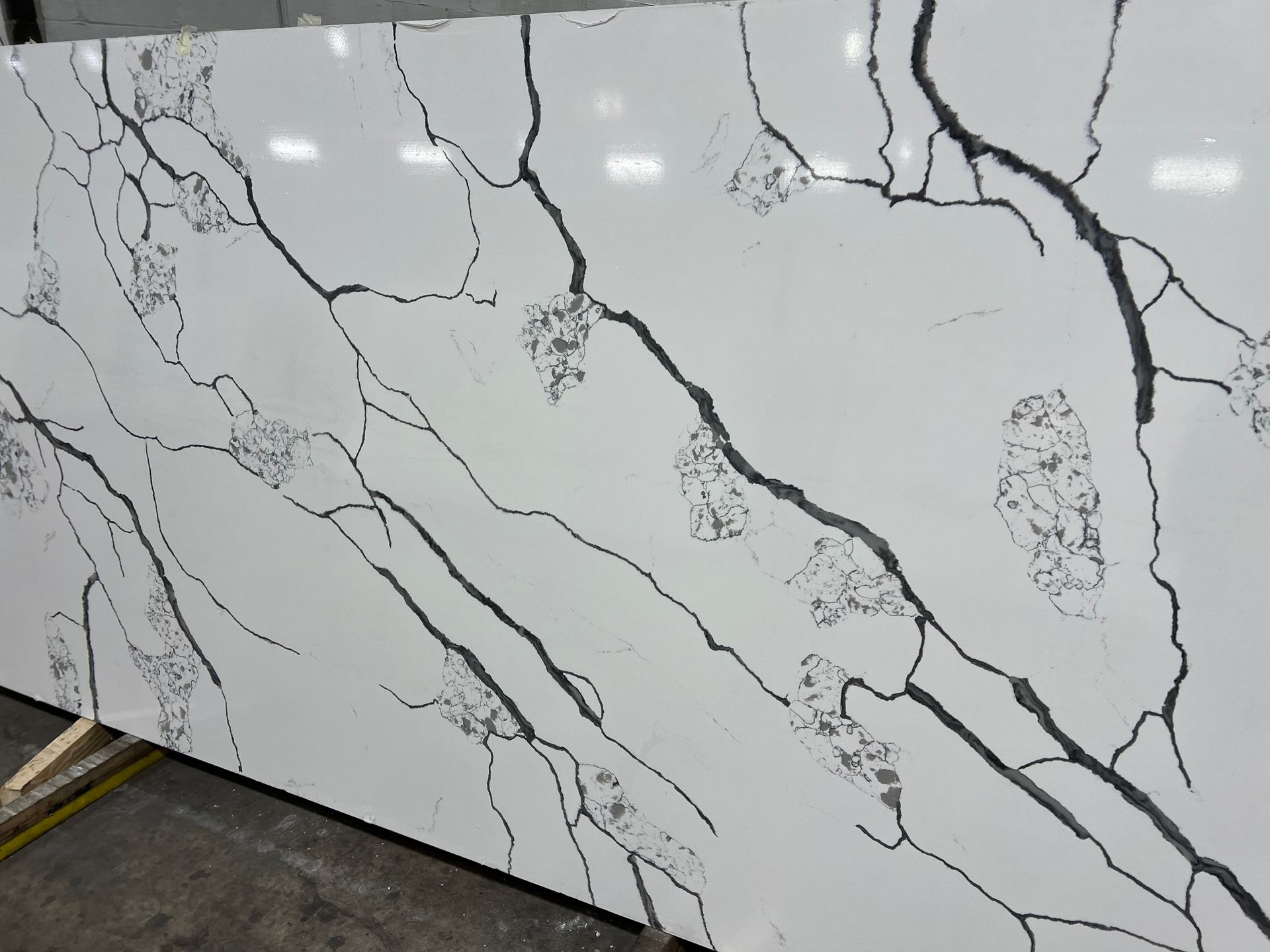 A white and black granite slab with a cracked pattern