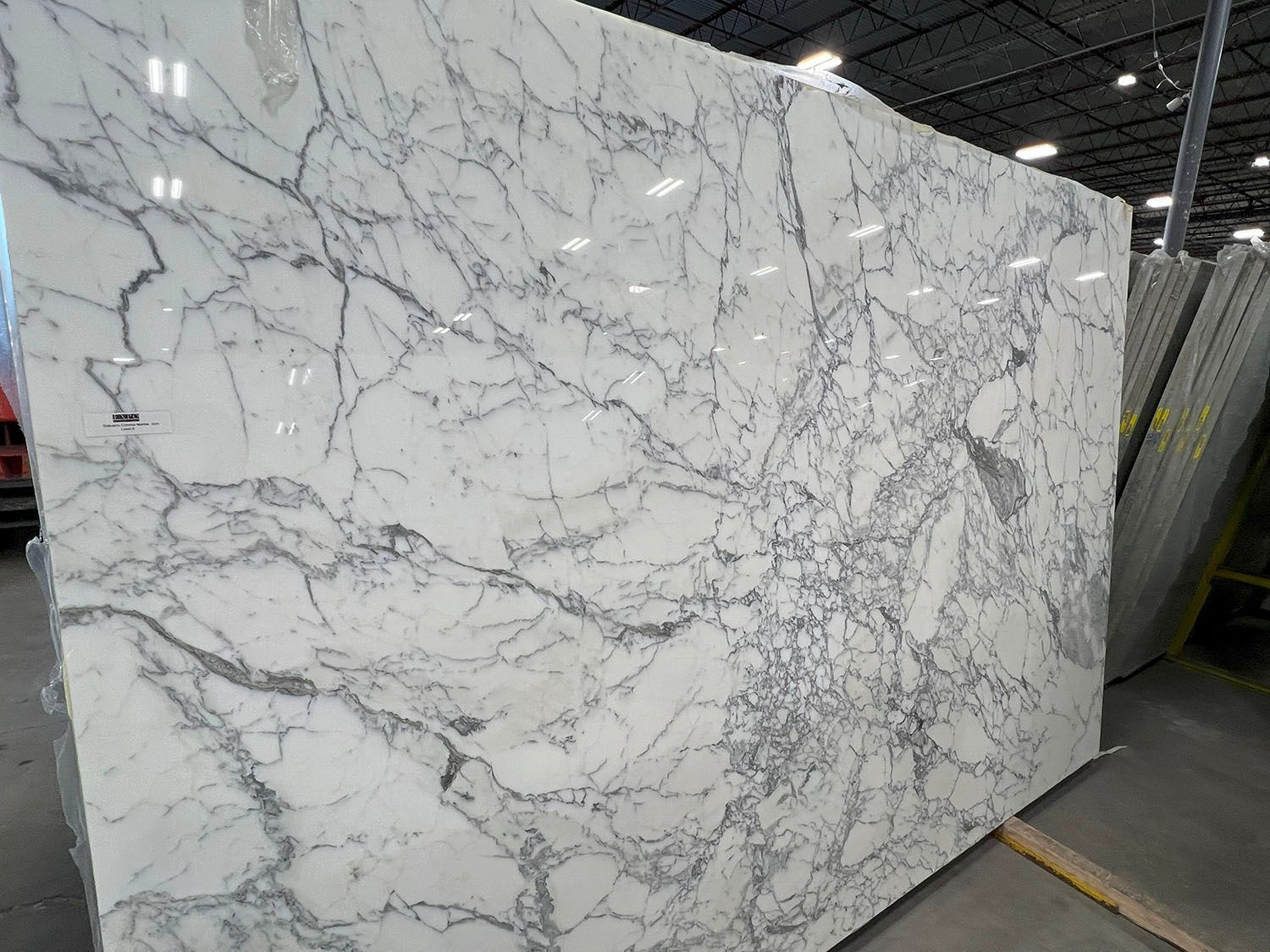 Large white marble slab with gray veining.