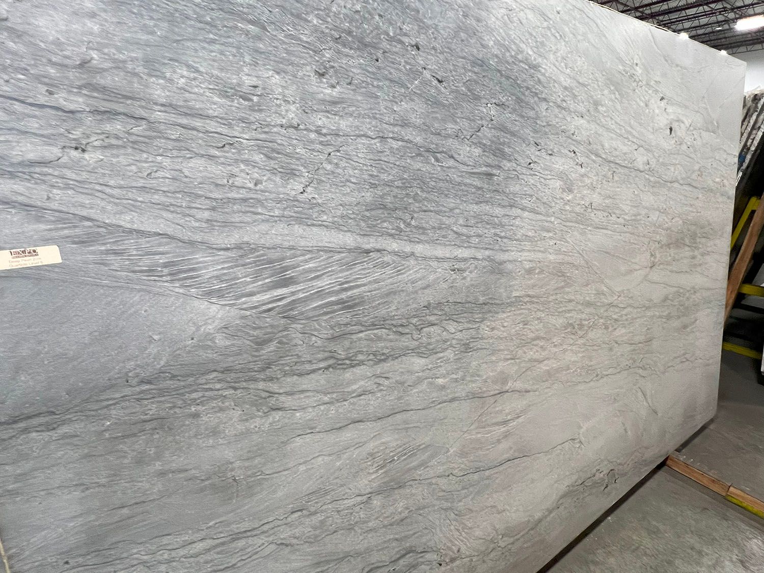 Large slab of gray granite with flowing, marbled pattern.