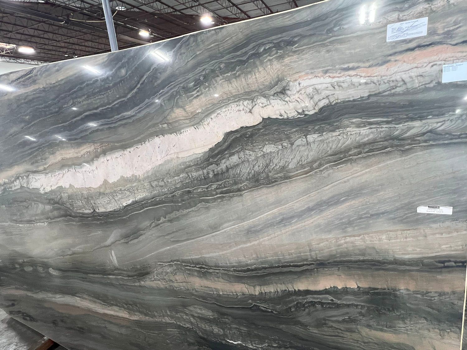 Large slab of blue, gray, and white marble with flowing, banded patterns.