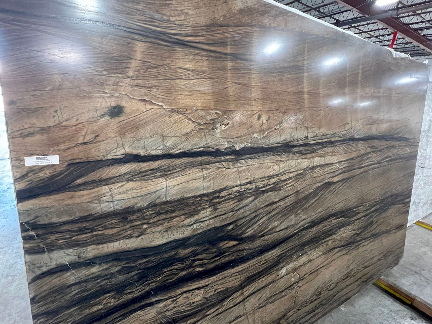 Large slab of granite with brown, black, and tan swirling patterns.