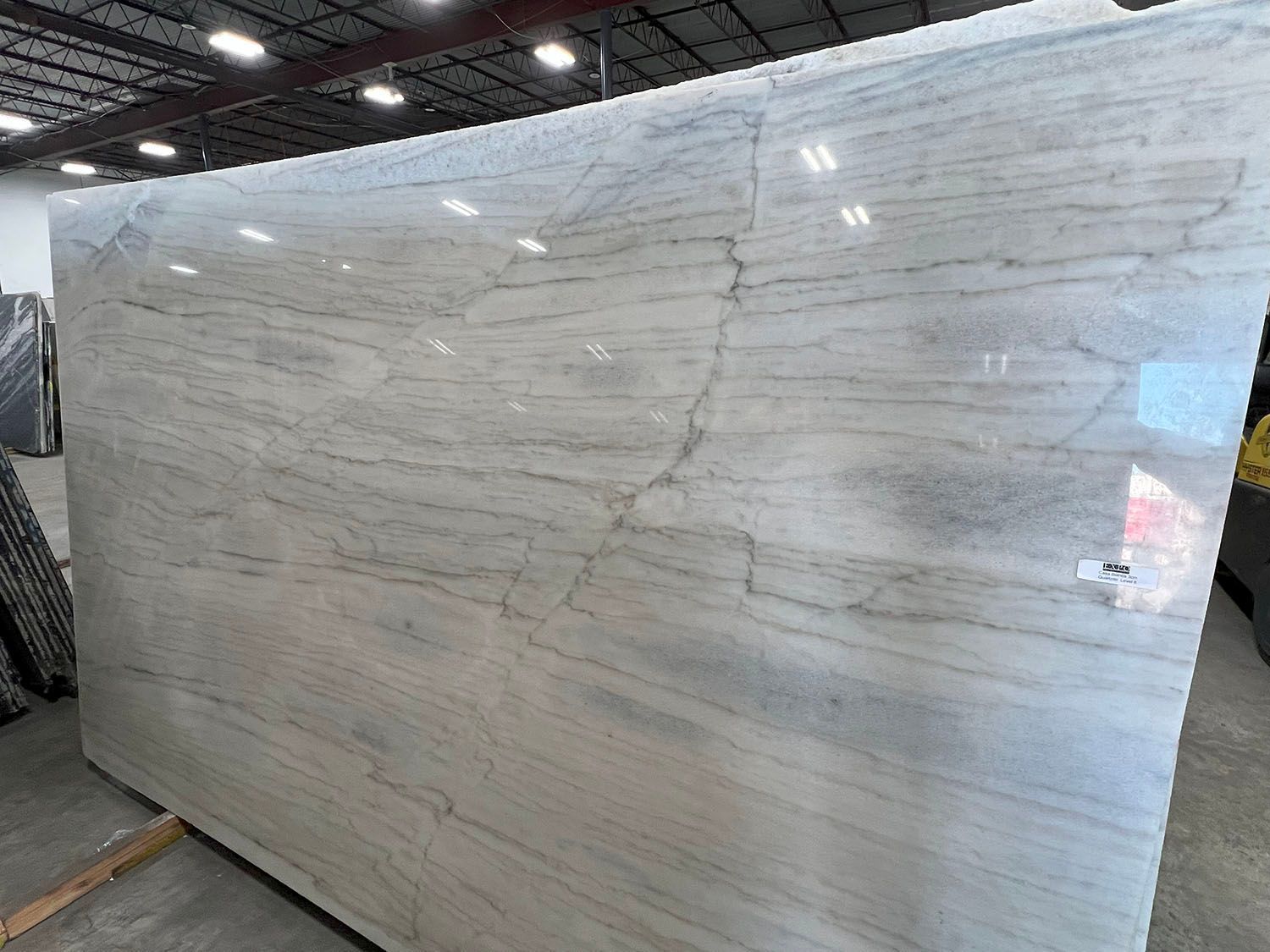 Large slab of white marble with gray veining, indoors.