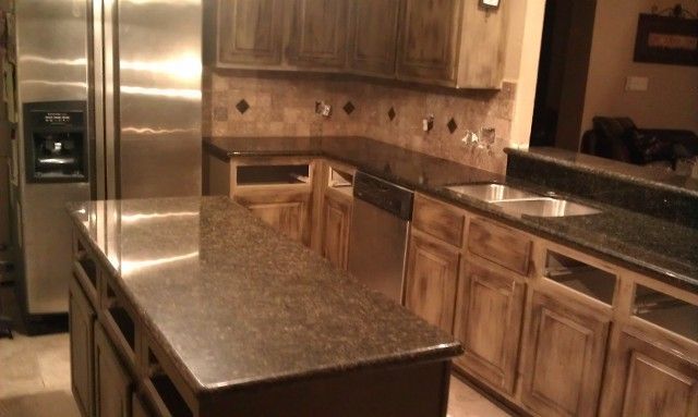 Kitchen with granite countertops, stainless steel appliances, and wood cabinets.