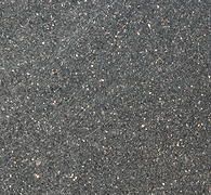 Dark gray, textured asphalt surface with small light-colored speckles.