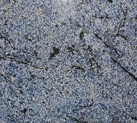 Blue granite countertop with black veining and white flecks.