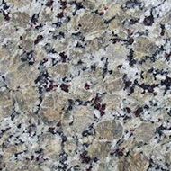 Granite countertop with speckled tan, black, white, and burgundy patterns.