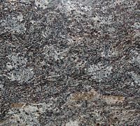 Granite countertop with swirled patterns in shades of gray, black, and tan.