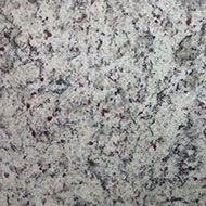 White granite countertop with speckled gray and maroon mineral deposits.