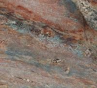 Close-up of granite surface with swirling patterns of red, blue, and tan colors.