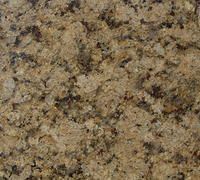 Close-up of golden granite countertop with black and brown speckles.