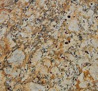 Close-up of granite countertop with tan, brown, and black speckled patterns.