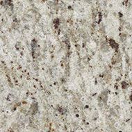 Close-up of granite with a light, speckled background and brown and black flecks.