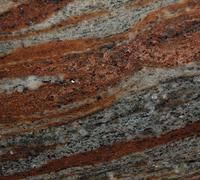 Swirling granite with red, gray, and white bands, resembling flowing layers.