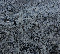 Jagged, cracked, and rough textured glacier surface in shades of grey.