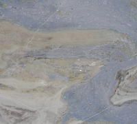 Abstract pattern with blue, tan, and gray swirls, resembling a landscape or geological formation.