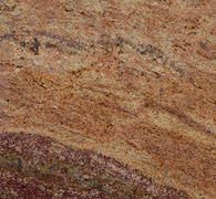 Orange and red granite stone with swirling patterns.