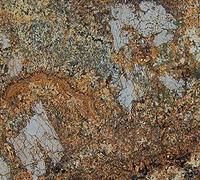 Close-up of a granite surface with a mix of brown, beige, gray, and speckled patterns.