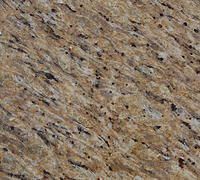 Close-up of golden brown granite countertop with black and gray speckles and wavy patterns.