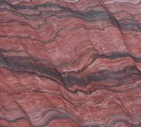 Red and gray layered stone surface with wave-like patterns.