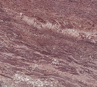 Red and brown stone with swirling layers and lighter bands.